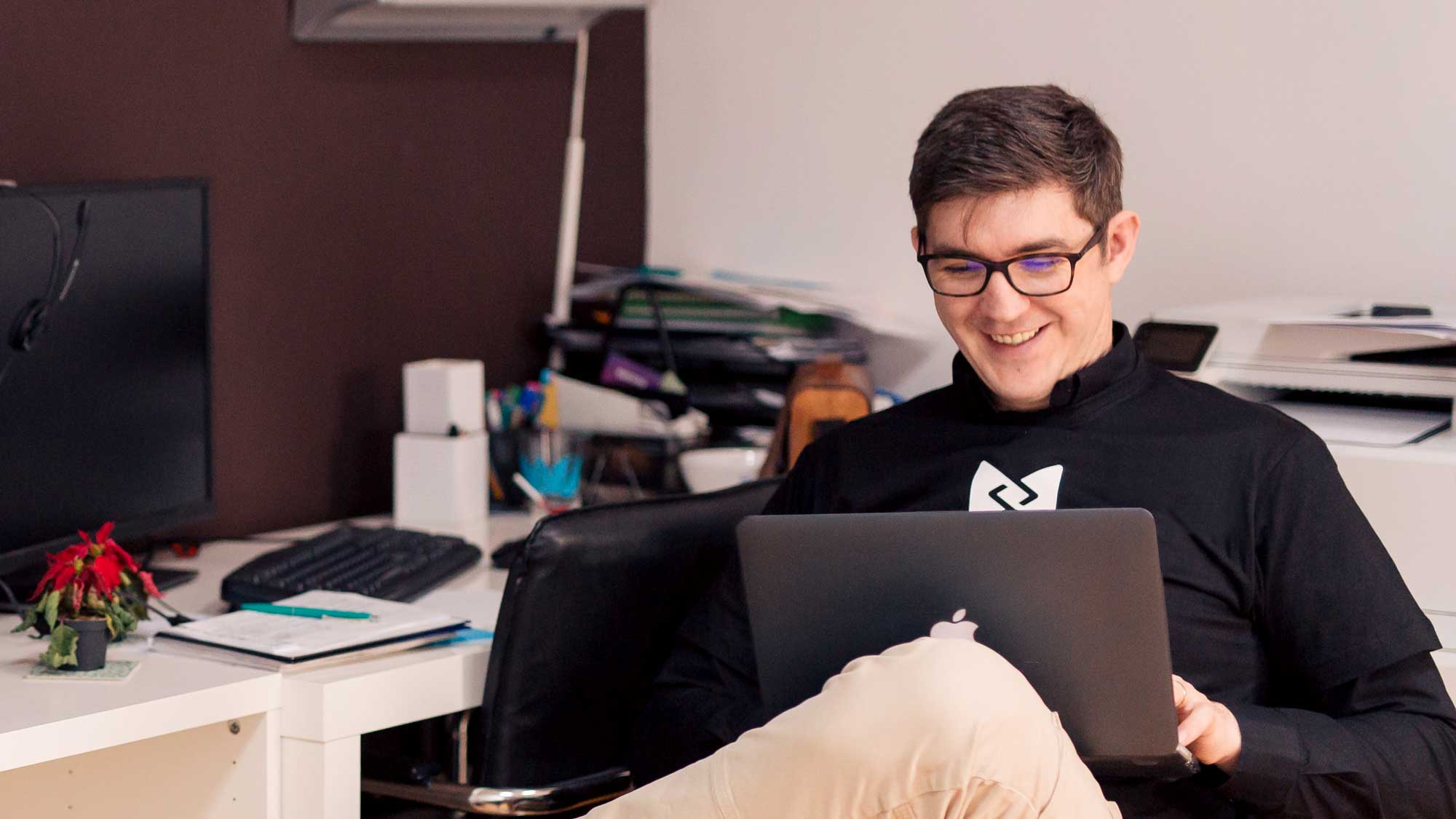 A young man using laptop in office