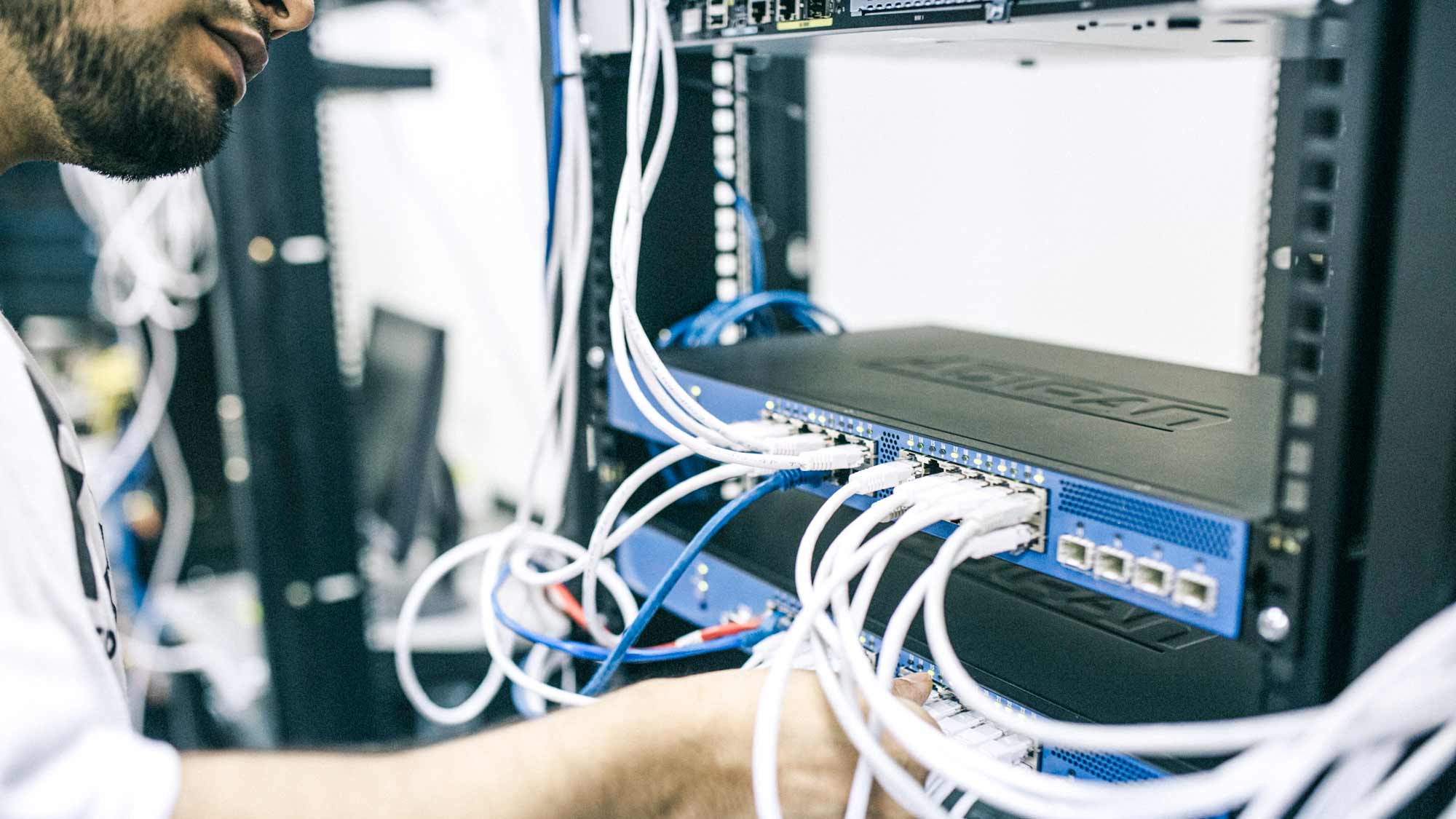 Man working near server and cables