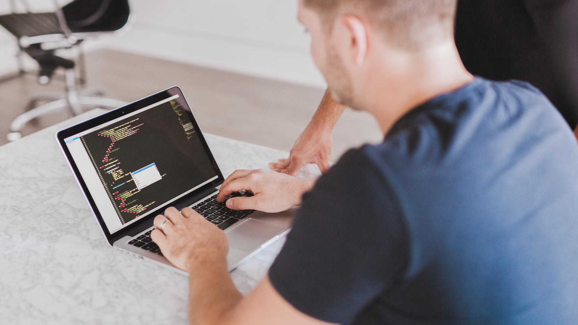 Man programing on computer