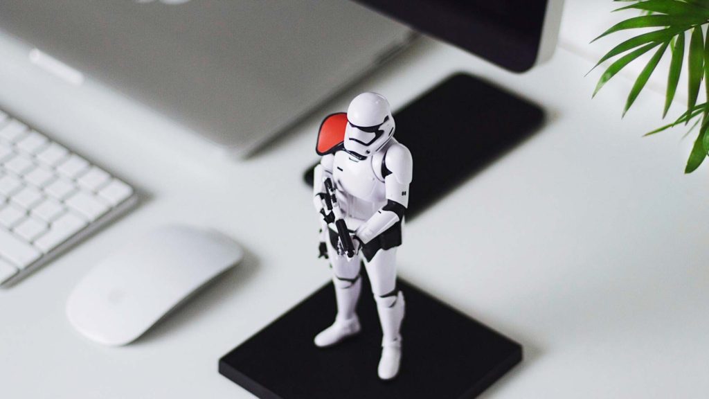 A stormtrooper guarding a computer from attack