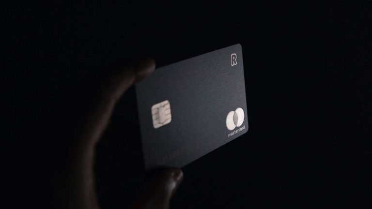 Black and gold credit card in dark shadow